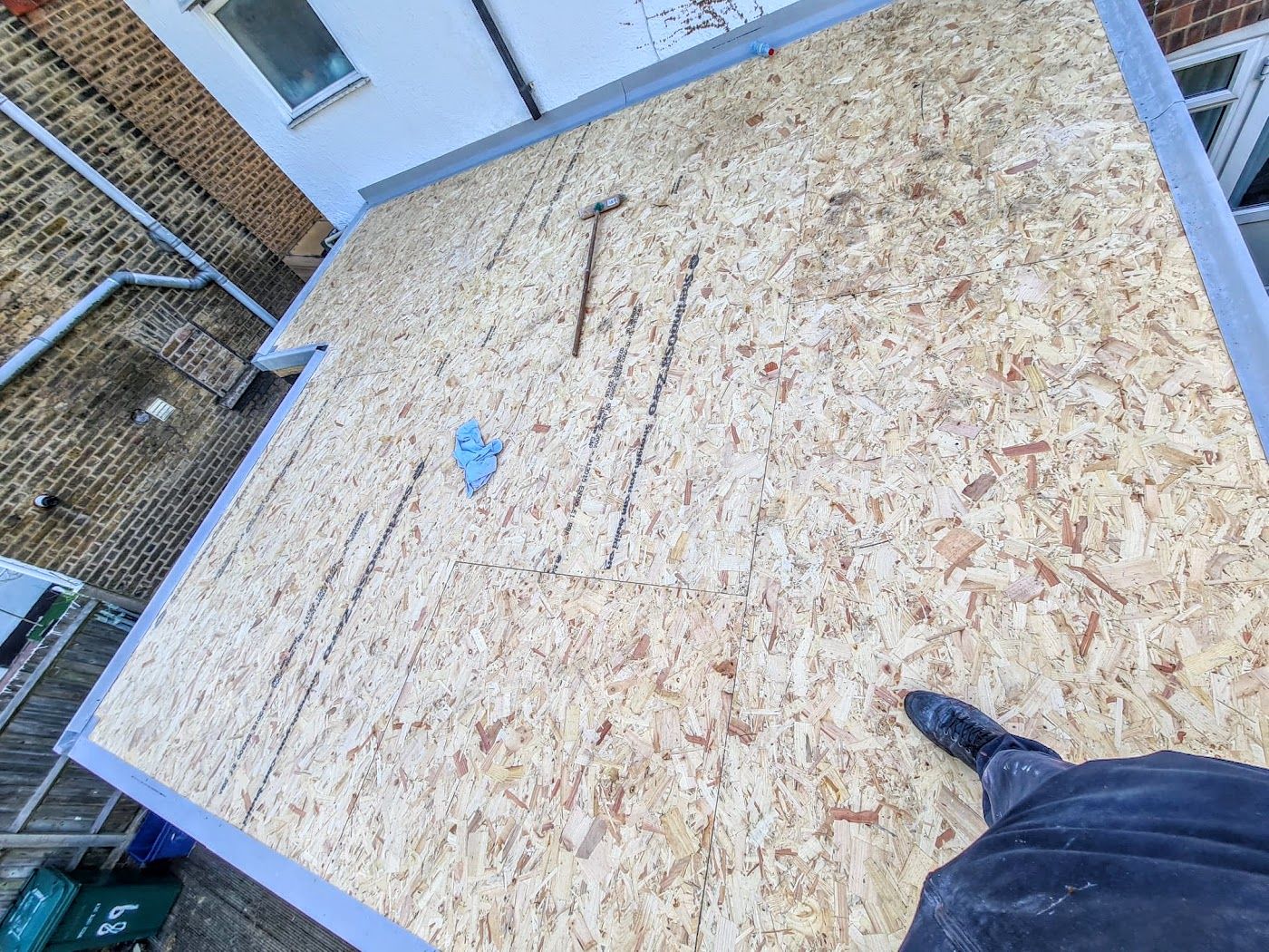 New OSB deck boards laid and taped on a flat roof