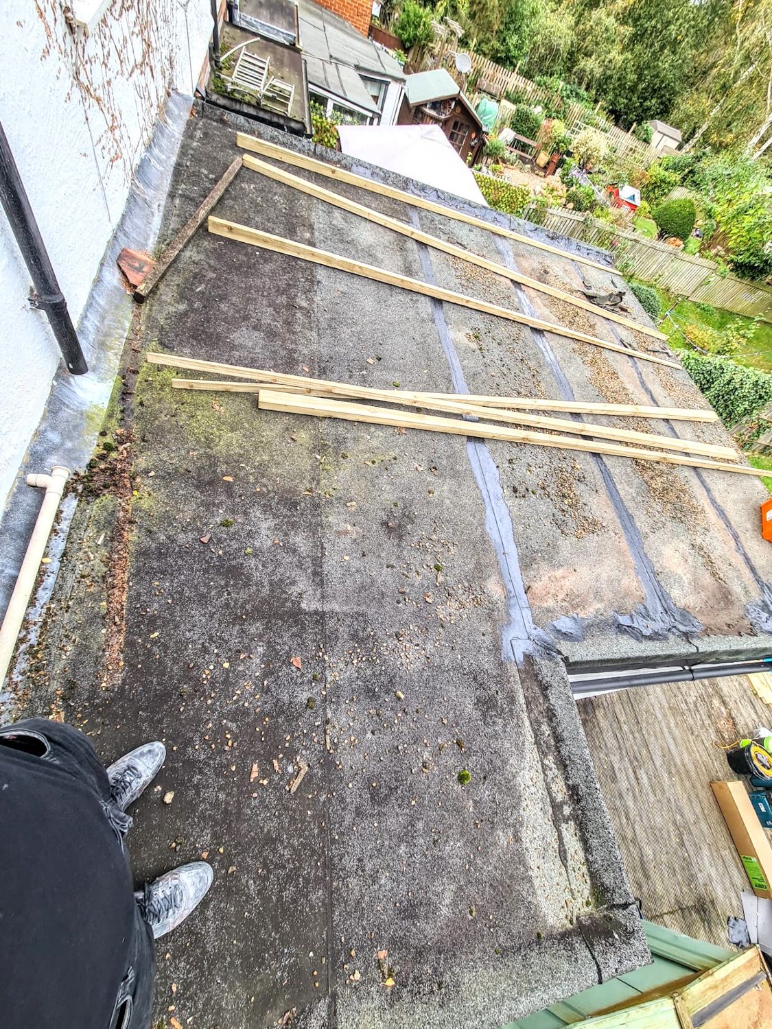 Old flat roof stripped back with timber battens laid across it