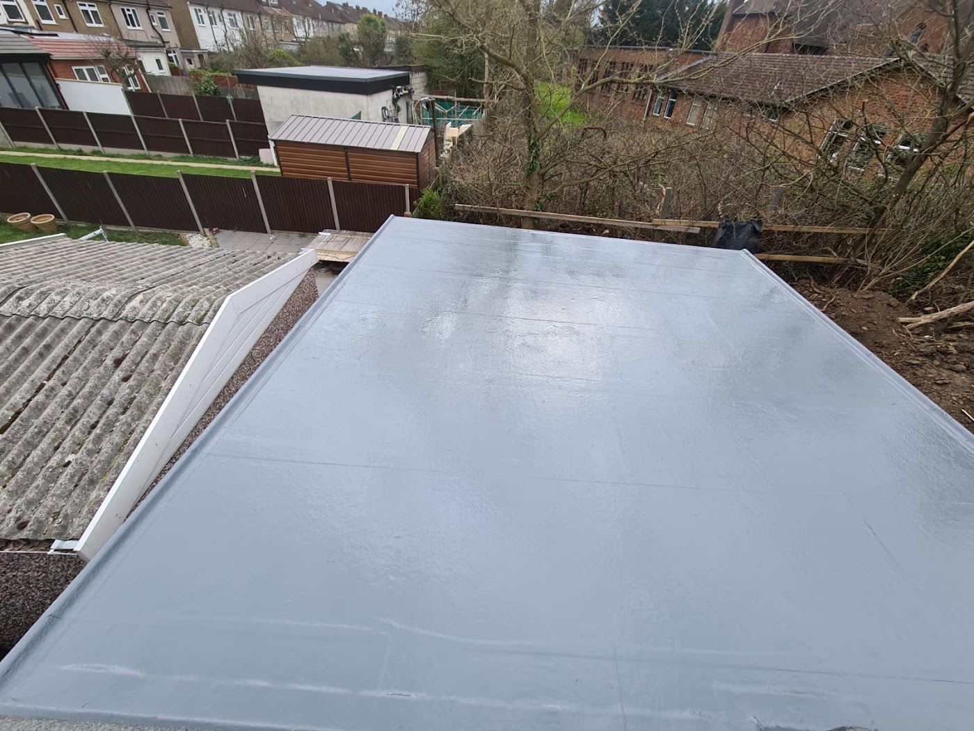 Grey fibreglass flat roof with a clean edge trim